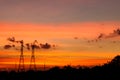 Two Mobile phone communication antenna tower with silhouette in sunset sky background Royalty Free Stock Photo