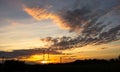 Mobile phone communication antenna tower with silhouette in sunset sky background Royalty Free Stock Photo