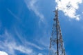 Mobile phone communication repeater antenna tower, with blue sky and white clouds Royalty Free Stock Photo