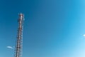 Mobile phone communication tower transmission signal with blue sky background and antenna, copy space Royalty Free Stock Photo