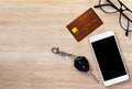 Mobile phone,credit card and key on wood texture background. Royalty Free Stock Photo