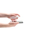 Mobile phone disinfection isolated on a white background. Men`s hands cleans the phone with a sanitizer.