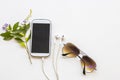 Mobile phone ,earphone and sunglasses of lifestyle woman relax arrangement flat lay style