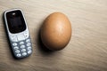 Mobile phone egg table background Royalty Free Stock Photo