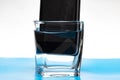 Mobile phone in a glass with water Royalty Free Stock Photo