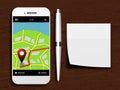 Mobile phone with gps application, pen and clean note lying on d Royalty Free Stock Photo