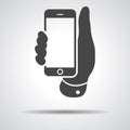 Mobile phone in hand icon on a grey background Royalty Free Stock Photo