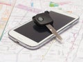 Mobile phone and key car on the map. Royalty Free Stock Photo