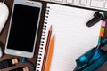 Mobile phone, keyboard, notebook and pencil on a table. Royalty Free Stock Photo