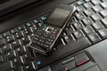 Mobile phone and laptop keyboard Royalty Free Stock Photo