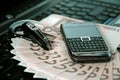 Mobile phone, laptop keyboard, bluetooth and cash Royalty Free Stock Photo