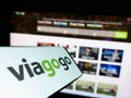 Mobile phone with logo of Aemrican ticket exchange platform company Viagogo on screen in front of website.