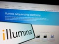 Mobile phone with logo of American genetics company Illumina Inc. on screen in front of business business website.