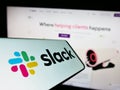 Mobile phone with logo of American software company Slack Technologies LLC on screen in front of website. Royalty Free Stock Photo