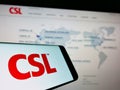 Mobile phone with logo of Australian pharmaceuticals company CSL Limited on screen in front of web page.