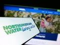 Mobile phone with logo of British company Northumbrian Water Limited on screen in front of business website. Royalty Free Stock Photo