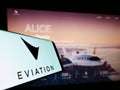 Mobile phone with logo of electric aircraft company Eviation Aircraft Ltd. on screen in front of website.