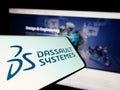 Mobile phone with logo of French software company Dassault Systemes SE on screen in front of website. Royalty Free Stock Photo