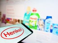 Mobile phone with logo of German chemical and consumer goods company Henkel on display in front of website. Royalty Free Stock Photo