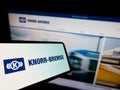 Mobile phone with logo of German manufacturing company Knorr-Bremse AG on screen in front of business website. Royalty Free Stock Photo