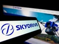 Mobile phone with logo of Japanese aviation company SkyDrive Inc. on screen in front of business website. Royalty Free Stock Photo