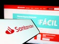 Mobile phone with logo of Spanish banking company Banco Santander S.A. on screen in front of website. Royalty Free Stock Photo