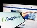 Mobile phone with logo of US electric motor company Regal Rexnord Corporation on screen in front of website.