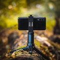 Mobile phone mounted to a small tripod for vlogging