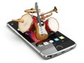 Mobile phone and musical instruments. Guitar, drums and trumpet. Royalty Free Stock Photo