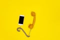 Mobile phone and old fashioned handset on yellow background. Royalty Free Stock Photo