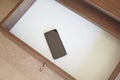 mobile phone in open drawer. Royalty Free Stock Photo