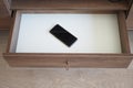 mobile phone in open drawer. Royalty Free Stock Photo