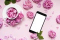 Mobile phone, pink flowers pink background. Place for text. Festive background. Mock up. Postcard template. Congratulation.