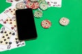 Mobile phone and poker chips with playing cards on a green table.online casino concept. Royalty Free Stock Photo