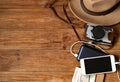 Mobile phone with powerbank on wooden table background. Royalty Free Stock Photo