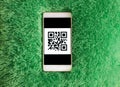 Mobile phone with qr-code on the screen. Artificial soft nap background