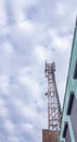 Mobile phone radio antenna tower. Cell tower against a cloudy sky, vertical photo Royalty Free Stock Photo