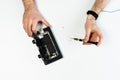 Mobile phone repairman hand on workplace flat lay
