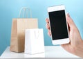 Mobile phone and shopping bags on line purchase concept.Internet shop