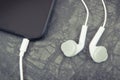 Mobile phone, smartphone with headphones. Relaxation time with music Royalty Free Stock Photo