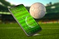 Mobile phone and soccer ball. Football app video game on smartphone and betting sport online concept