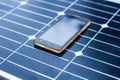 Mobile phone on a solar panel outdoor close up
