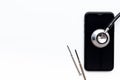 Mobile phone with stethoscope, electronics repair concept Royalty Free Stock Photo