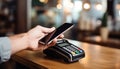 Mobile phone, touch a credit card reader on the counter bar. Royalty Free Stock Photo