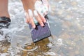 Mobile phone in water and foam, in the hands with a sponge Royalty Free Stock Photo