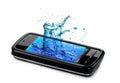 Mobile phone with water splashing out of the monit