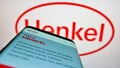 Mobile phone with webpage of consumer goods company Henkel AG Co. KGaA on screen in front of business logo. Royalty Free Stock Photo