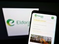 Mobile phone with website of Brazilian pulp manufacturer Eldorado Brasil Celulose S.A. on screen with logo.