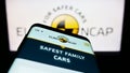 Mobile phone with website of car safety programme Euro NCAP on screen in front of logo. Royalty Free Stock Photo