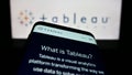 Mobile phone with website of US company Tableau Software Inc. on screen in front of business logo.
